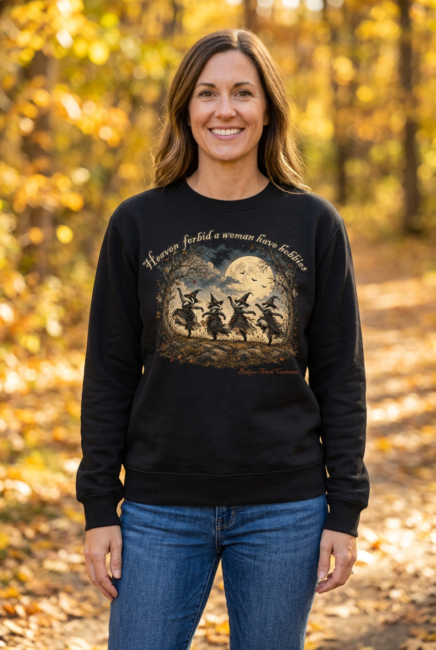 Woman wearing the witch badger crewneck on an autumn woodland path